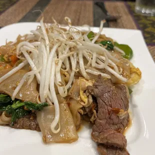 a plate of beef and noodles