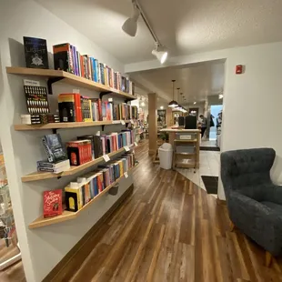 a room with bookshelves and chairs