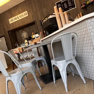 a counter and chairs in a coffee shop