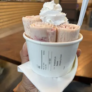 Strawberry and banana ice cream with whipped cream.