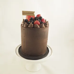 a chocolate cake with berries on top