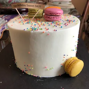 a white cake with colorful sprinkles