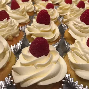 Raspberry cupcakes filled with raspberry mouse, topped with buttercream frosting.