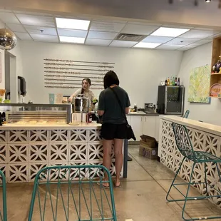 two people standing at a counter