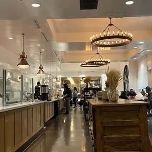 Inside. Very industrial looking decor with plenty of tables and chairs.