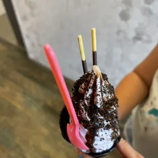 a woman holding a cup of ice cream