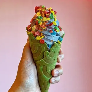 Black Pink Soft serve with fruity pebbles on a Matcha Cone