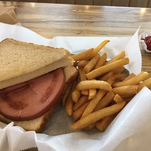 Fried bologna sandwich and hot crisp fries.  Might as well call it the heart stopper but it sure is good!