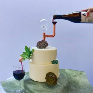 a person pouring wine into a cake