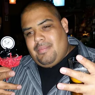 a man holding a pint of beer