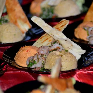Moroccan Spiced Rock Shrimp &amp; Trio of Hummus - Traditional, Edamame, and Spicy Red Pepper garnished with Tabbouleh, Pita Chips