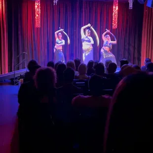 a group of dancers performing on stage