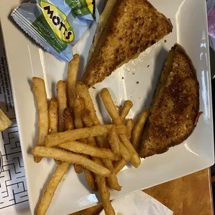 Kids grilled cheese with side of fries and Mott&apos;s fruit snacks.