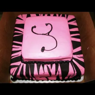 a pink and black zebra print cake