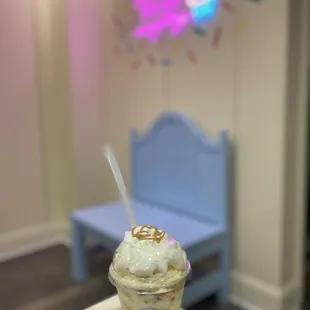 a cup of ice cream with a spoon sticking out of it