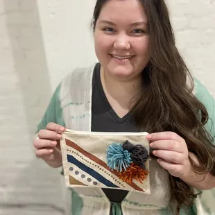 My cousin with her bag she painted and glued chosen pom poms