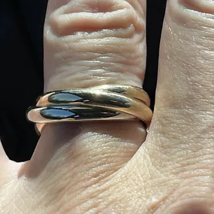 This design is a combination of our original wedding rings and our parents rings. The three rings represent the Father, Son, and Holy Spirit