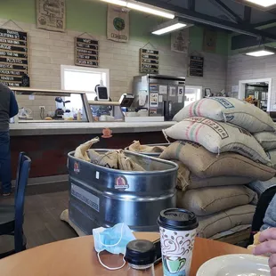 a man sitting at a table in a coffee shop