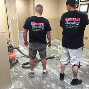 Shirts by CVP in Stockton being worn while installing the floor in Lodi Costco Optometry center.