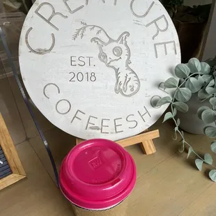 a cup of coffee and a sign