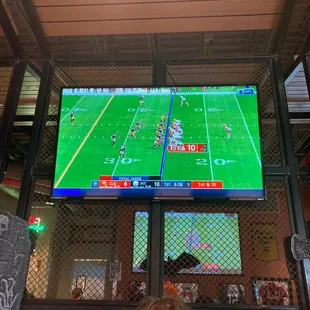 a man watching a football game on a tv