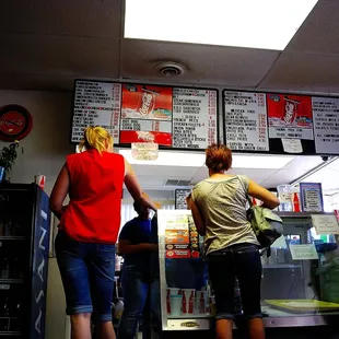 two people standing in front of a vending machine