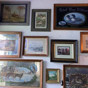 a wall of framed art