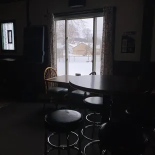a table and chairs in a dark room