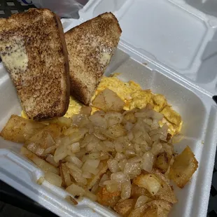 a breakfast of eggs, toast, and hash browns