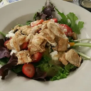 a salad with chicken and strawberries