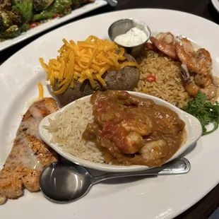Trio entree with grilled shrimp, shrimp étouffée, and salmon.