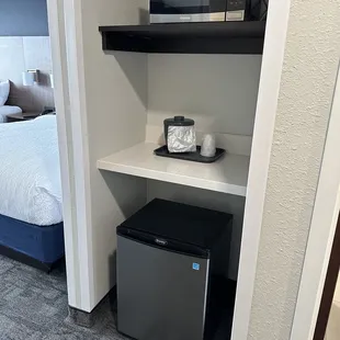 Microwave and fridge in room