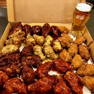 a box of chicken wings and a glass of beer