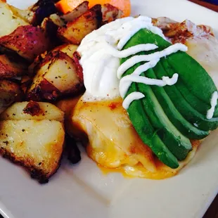 Breakfast crêpe with eggs, cheese, chorizo, potatoes, sour cream, and avocado. Very tasty.