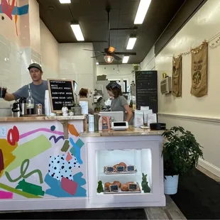 a man and a woman behind the counter