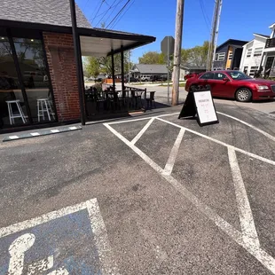 a parking lot with a red car