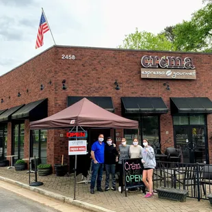 a group of people standing in front of a building