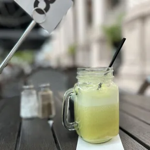 a jar of lemonade with a straw and a spoon