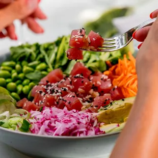 a woman eating a bowl of food