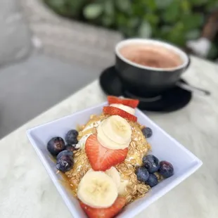  bowl of fruit and a cup of coffee