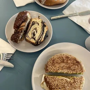 two plates of pastries and a sandwich