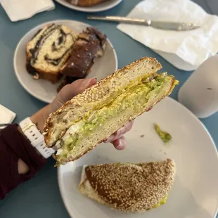 a person holding a sandwich