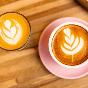two cups of coffee on a wooden table