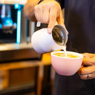 a man pouring a cup of coffee
