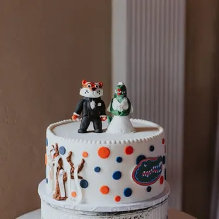 a wedding cake decorated with figurines