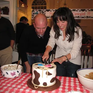 Cutting the cake to reveal if it&apos;s a boy or a girl!