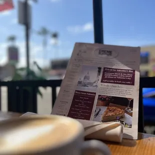 a menu and a cup of coffee