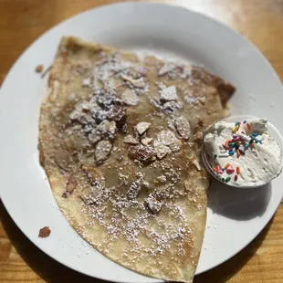 Gauloise Crepe: filling is apple, cinnamon, brown sugar. Topped with toasted almonds, powder sugar, and house made whipped cream.