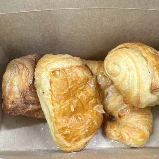 Butter croissant, chocolate croissant, sausage roll, and crème filled cruffin.