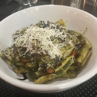 a bowl of pasta with pesto sauce